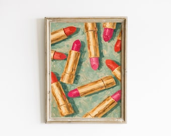 May include: A framed print featuring an artistic arrangement of lipsticks. The lipsticks, in shades of red and pink, are set against a teal background. The lipstick tubes are gold. The artwork is in a vintage style.