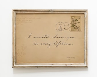 May include: A framed print on tan paper resembling an old envelope with the text I would choose you in every lifetime. It features a 15 cent postage stamp with a floral design, a postmark dated JUN 18 1957, and faint cursive handwriting.