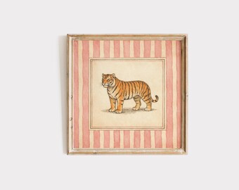 May include: A square framed wall art piece featuring a central illustration of an orange and black tiger standing on a cream-colored background. The tiger is enclosed within a double-lined border, surrounded by a pink and white vertical striped pattern.