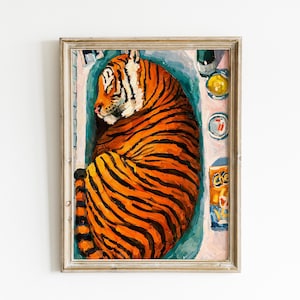 May include: A framed painting of an orange and black striped tiger curled up inside a light blue bathtub. Beside the tub are a yellow bowl, a small dish, and an orange box with the text Cheez-It visible on the label, all set in a frame.