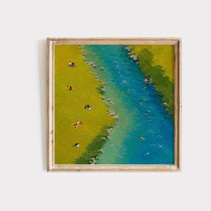 May include: A square framed painting depicting an aerial view of a vibrant blue river flowing through a bright yellow-green grassy landscape. Small figures are scattered along the riverbank and one person is swimming in the water.