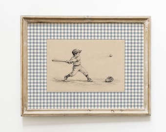 May include: A framed wall art piece featuring a black and white ink illustration of a baseball player swinging a bat at a ball. The artwork is set against a blue and white gingham patterned matting and enclosed in a light-toned wooden frame.