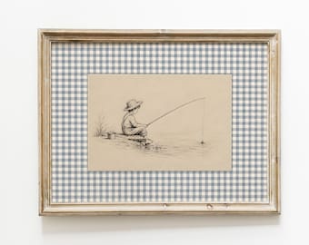 May include: A framed wall art piece featuring a black ink sketch of a child wearing a hat and overalls while fishing on a dock. The artwork is set against a light blue and white gingham patterned matting inside a weathered light wood frame.