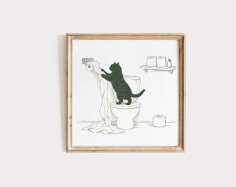 May include: A framed print featuring a black cat on a toilet, playfully unraveling a roll of toilet paper. The artwork is a black and white illustration with a humorous theme, perfect for bathroom decor. The print is in a wooden frame.