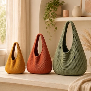 May include: Three teardrop-shaped crochet bags in graduated sizes. The smallest bag is mustard yellow, the medium bag is burnt orange, and the largest bag is sage green. Each bag features a single integrated handle and a dense, textured stitch.