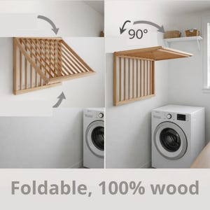 May include: A light-coloured wooden wall-mounted drying rack with a slatted design. The rack features a foldable mechanism that allows it to transition from a vertical position to a horizontal 90-degree angle. The text reads Foldable, 100% wood.