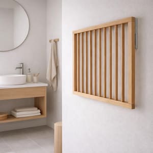 May include: A light-colored wooden wall-mounted towel rack with vertical slats. The rack is rectangular and mounted on a white wall in a bathroom setting. The bathroom also features a sink, mirror, and other wooden fixtures.