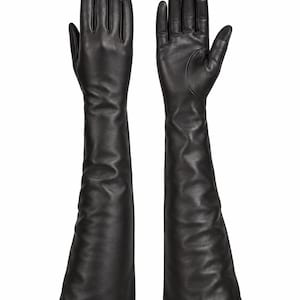 May include: A pair of long, black leather opera-length gloves. The gloves feature a smooth, matte finish and extend well past the wrist, reaching toward the forearm. The design includes stitched finger seams and a tailored fit for the hand and fingers.