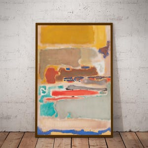 Puede incluir: Pintura abstracta en un marco de madera marr&oacute;n. La obra presenta bloques de color en tonos de amarillo, marr&oacute;n, rojo, azul y gris. La pintura se exhibe contra una pared blanca y un suelo de madera.