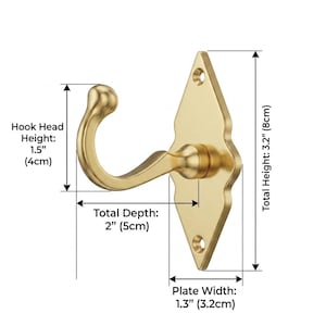 May include: A gold-colored wall hook with a decorative diamond-shaped backplate. The hook head is 1.5 inches (4cm) high, with a total depth of 2 inches (5cm). The plate width is 1.3 inches (3.2cm), and the total height is 3.2 inches (8cm).