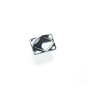 May include: A shiny, silver-colored square cabinet knob with a geometric, diamond-like design. The knob has a reflective surface, creating highlights and shadows. The hardware is set against a plain white background.