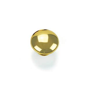 May include: A shiny, gold-colored cabinet knob with a smooth, spherical design. The knob reflects light, creating bright highlights. The hardware is likely for furniture such as drawers or cabinets.