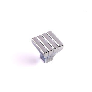 May include: A polished chrome cabinet knob with a square, ridged design. The knob features four parallel rectangular bars on top and a curved base. This hardware is suitable for drawers and cabinets.