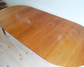 Danish Mid Century Modern Hanning Kjaernulf Teak Round to Oval Dining Table with Three Leaves and Protective Covers  Made in Denmark