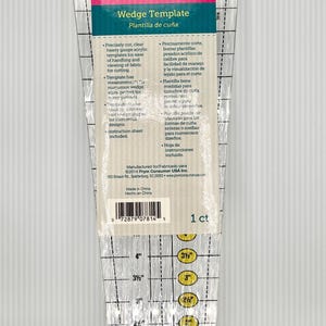 May include: A clear acrylic Fons & Porter wedge template for quilting, featuring black grid lines and printed measurements in inches. The packaging includes text detailing strip width and finished size, with yellow circles highlighting specific inch increments.