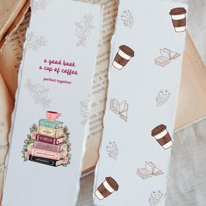 May include: Two light blue bookmarks with a torn edge. One bookmark features a stack of books with a coffee cup on top, surrounded by flowers, and the text "a good book, a cup of coffee, perfect together." The other bookmark has coffee cups and books.