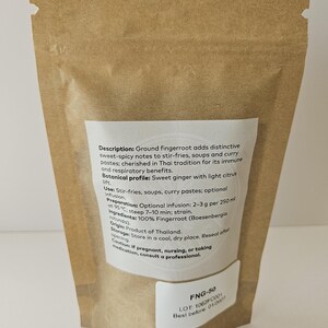 May include: A brown paper bag containing ground fingerroot. The bag features a white label detailing the product's description, usage, preparation, ingredients, and origin. The text on the label is in English.
