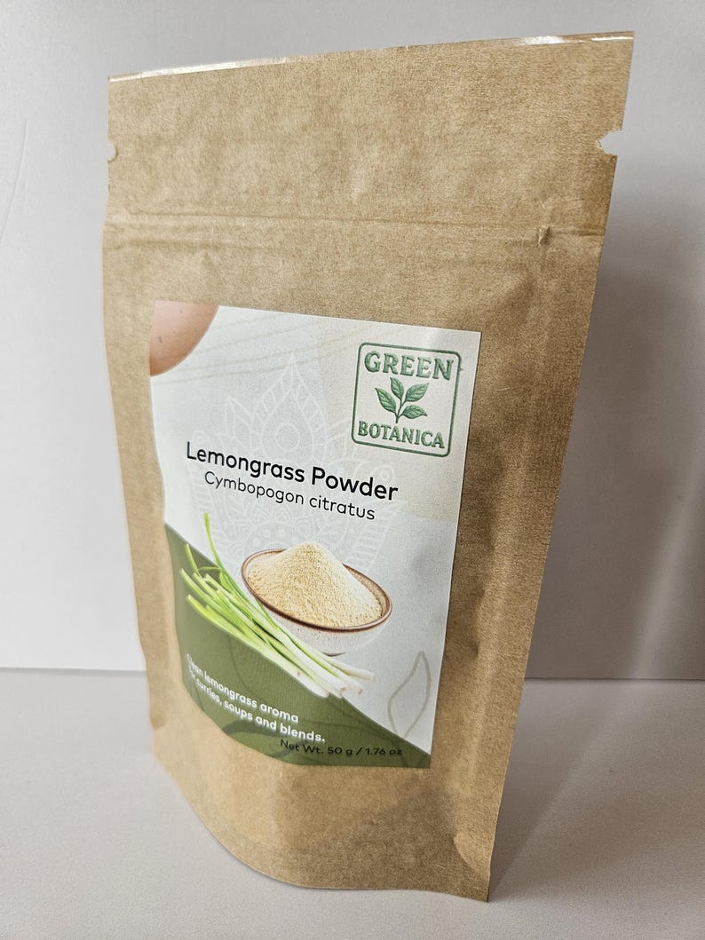 Pode incluir: Um saco de papel castanho com um r&oacute;tulo com o texto "Lemongrass Powder" e a marca "Green Botanica". O r&oacute;tulo mostra uma tigela de p&oacute;, caules de capim-lim&atilde;o e o texto "lemongrass aroma". O peso l&iacute;quido &eacute; de 50 g.