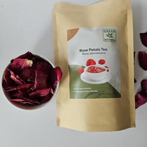 May include: A package of Green Botanica Rose Petals Tea, Rosa damascena, with a bowl of dried rose petals. The package is tan with a green label and a picture of tea. The text on the package says "Soft rose aroma for elegant tea rituals." The net weight is 50 g / 1.7 oz.
