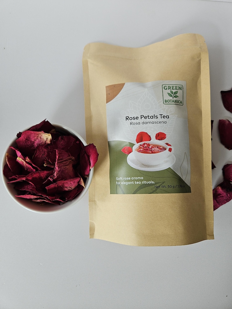 May include: A package of Green Botanica Rose Petals Tea, Rosa damascena, with a bowl of dried rose petals. The package is tan with a green label and a picture of tea. The text on the package says "Soft rose aroma for elegant tea rituals." The net weight is 50 g / 1.7 oz.