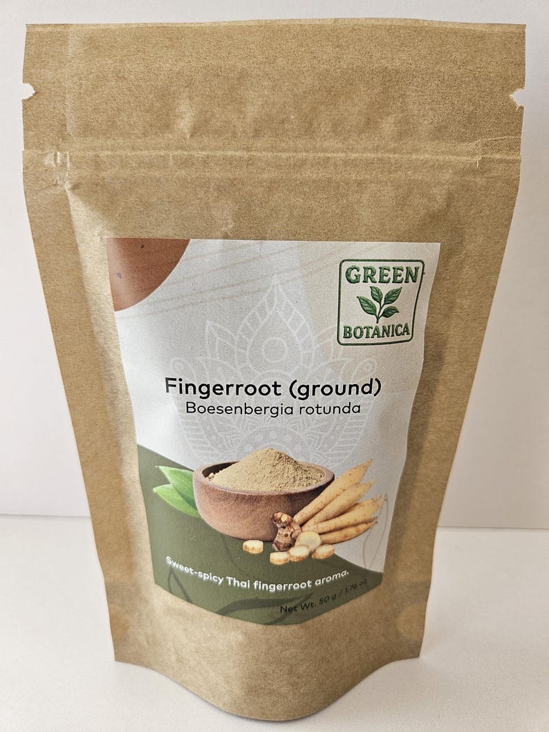 May include: A brown paper bag of ground fingerroot, labelled "Green Botanica." The label features an illustration of fingerroot and a bowl of powder. Text on the label reads "Fingerroot (ground) Boesenbergia rotunda" and "Sweet-spicy Thai fingerroot aroma." Net weight is 50g.
