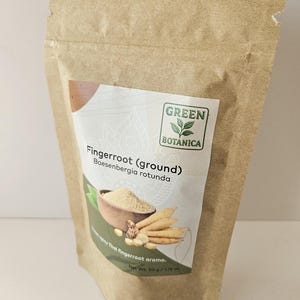 May include: A brown paper bag of Green Botanica fingerroot (ground). The label shows an illustration of fingerroot and the text "Boesenbergia rotunda". The net weight is 50 g / 1.76 oz.