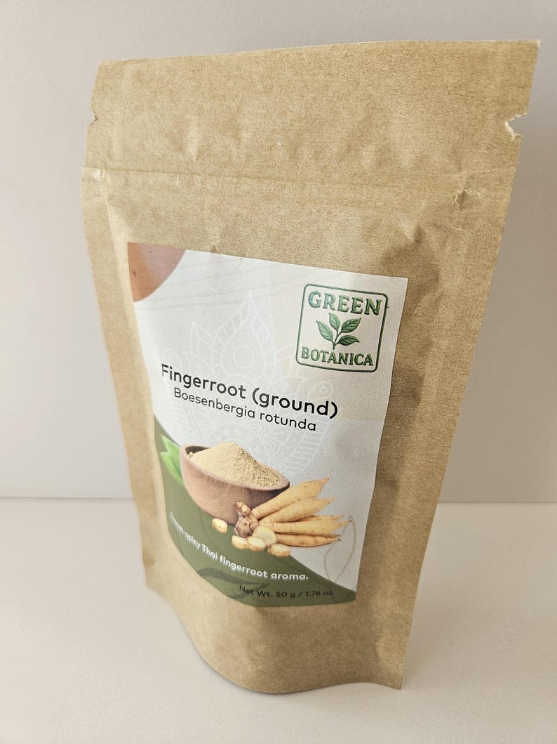 May include: A brown paper bag of Green Botanica fingerroot (ground). The label shows an illustration of fingerroot and the text "Boesenbergia rotunda". The net weight is 50 g / 1.76 oz.