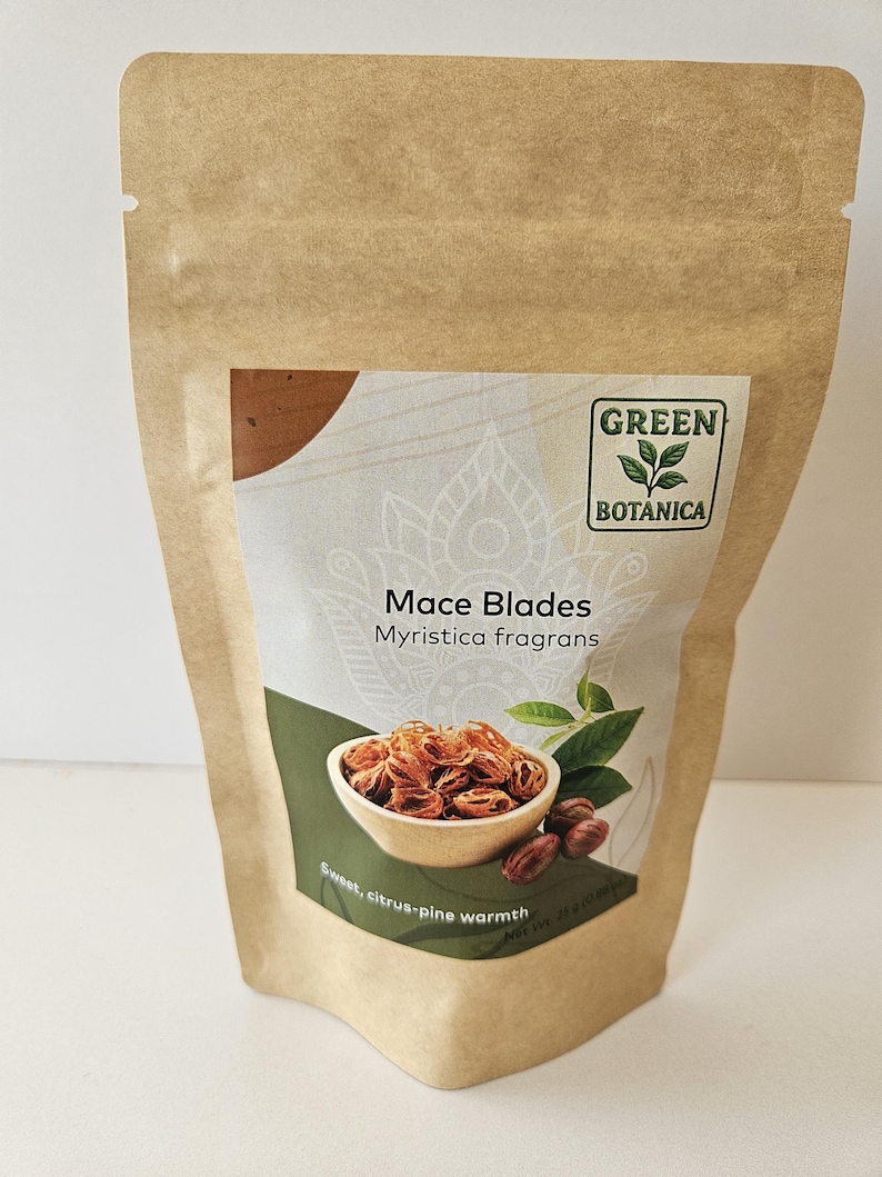 K&ouml;nnte beinhalten: Ein brauner Standbodenbeutel aus Kraftpapier mit dem Etikett Green Botanica Mace Blades Myristica fragrans. Das Etikett zeigt eine Grafik von Muskatbl&uuml;ten in einer kleinen Schale, gr&uuml;ne Bl&auml;tter sowie den Text Sweet, citrus-pine warmth und Net Wt. 25 g (0.88 oz).