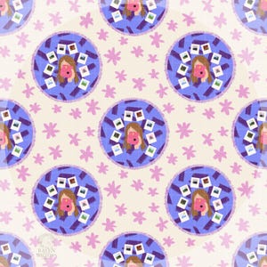 May include: A repeating pattern featuring illustrations of a person holding a pink camera, surrounded by instant photos, within a blue circle. The circles are set against a cream background with pink star-shaped flowers.