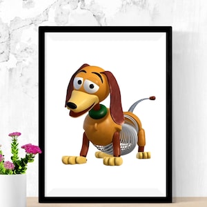 May include: Framed print featuring a cartoon dachshund toy. The dog has a yellow body, brown ears, and a green collar. Its midsection is a silver spring. The artwork is set against a white background, framed in black.