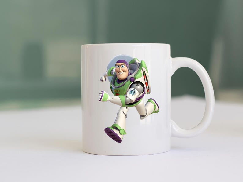 May include: White ceramic mug featuring a full-color image of Buzz Lightyear from Toy Story. The character is depicted in his signature green, white, and purple spacesuit, mid-stride. The mug has a curved handle.