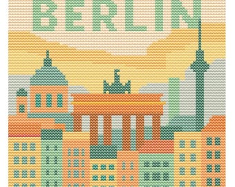 May include: A cross-stitch design featuring a cityscape of Berlin, Germany. The image includes the Brandenburg Gate, the Berlin TV Tower, and other buildings. The word "BERLIN" is stitched across the top in green letters. The color palette includes orange, green, and yellow.