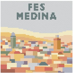 May include: Cross-stitch artwork depicting the city of Fes Medina. The design features a cityscape with buildings in shades of orange, red, and blue, under a gray sky. The words "FES MEDINA" are stitched across the top.