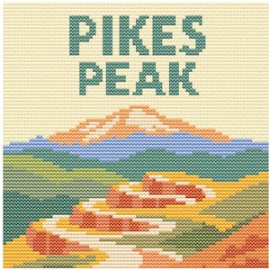 May include: Cross-stitch design featuring the words "PIKES PEAK" in teal above a mountain landscape. The mountain has a light orange peak, blue and green hills, and a winding road in shades of orange and yellow.