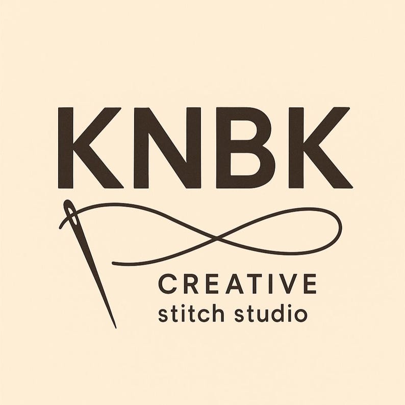 May include: Logo for a creative stitch studio, featuring the letters "KNBK" in a dark brown font above the words "CREATIVE stitch studio" in a smaller font. A needle and thread design is incorporated into the logo.