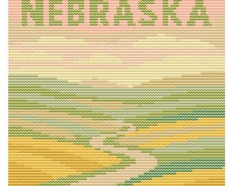 May include: Cross-stitch artwork featuring the word "NEBRASKA" in green block letters above a landscape scene. The landscape depicts rolling hills and a winding path in shades of yellow, green, and beige, under a pink and yellow sky.
