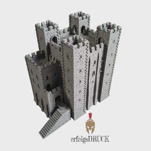 May include: A gray, 3D-printed miniature castle model featuring four crenelated corner towers, stone-textured walls, arched doorways, and a staircase leading to the main entrance. The logo for erfolgsDRUCK is visible at the bottom of the image.
