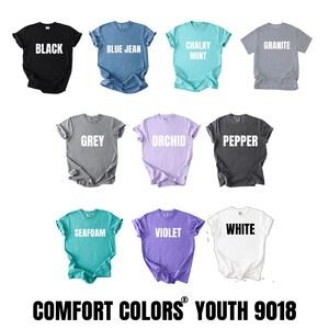 a collection of t-shirts in various colors, including black, blue, green, grey, orchid, pepper, sea foam, violet, and white.