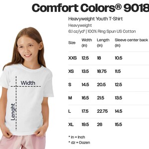 a young girl wearing a white t-shirt and pink pants, posing for a photo.