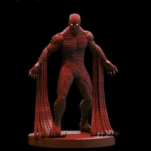 May include: A red, textured figurine of a humanoid creature with glowing yellow eyes. The figure has clawed hands and long, flowing appendages. It stands on a circular base against a black background.