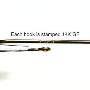 May include: Close-up of a gold-toned hook with the marking "14K GF" stamped on it. Each hook is stamped 14K GF.