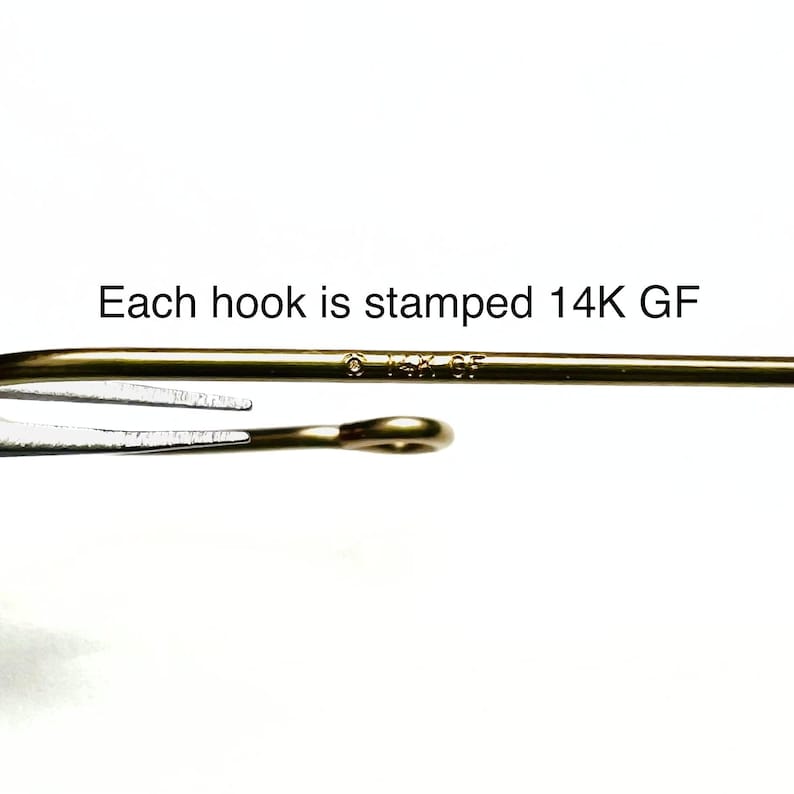 May include: Close-up of a gold-toned hook with the marking "14K GF" stamped on it. Each hook is stamped 14K GF.