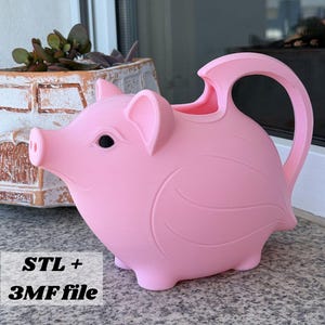 May include: A light pink watering can shaped like a pig with a snout, ears, and a curved handle. The body features embossed wing-like details on the sides. The text "STL + 3MF file" is visible in the lower left corner of the image.