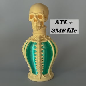 May include: A 3D printed bottle featuring a skull-shaped stopper and a skeletal ribcage design in cream-colored material with metallic green panels. The text STL + 3MF file is printed in black on a light gray rectangular background next to the bottle.