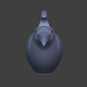 May include: A matte lavender-gray 3D rendered figurine of a bird, viewed from the front. The bird features a pointed beak, defined eyes, and stylized wing markings on its sides, with a prominent crest extending upward from the top of its head.