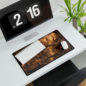 May include: A rectangular mouse pad featuring a detailed steampunk city design in shades of brown and gold. A white keyboard and mouse sit on the pad, next to a computer monitor displaying the time. The pad is on a white desk.