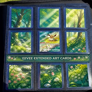 May include: A black trading card binder page containing nine square cards. Eight cards feature a continuous forest landscape with green trees and flowers. The centre card is an Eevee character card with text reading EEVEE EXTENDED ART CARDS.
