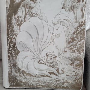 May include: A white binder featuring a monochromatic brown illustration of a large nine-tailed fox and a smaller six-tailed fox sitting together in a forest setting with trees, ferns, and flowers. The design covers the front cover of the binder.