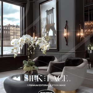 May include: An interior design scene featuring a black and gold coffee table, two gray armchairs with black fur cushions, and a large framed picture. The scene is accented by white orchids and the text "SILK AND LACE".