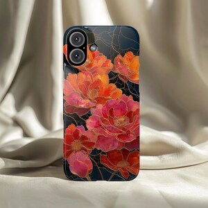 May include: A smartphone case featuring a floral design. The case has a dark blue background with vibrant red and orange flowers. Gold-colored lines outline the flowers, adding detail to the design.